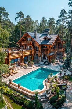 an aerial view of a large log home with a swimming pool