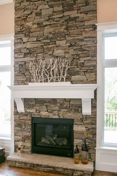 a living room with a fire place and stone fireplace