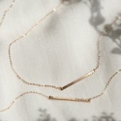 "The daintiest personalized necklace you'll ever meet--like a secret just for you! Perfect for teeny initials or other mini inscriptions you want to keep close. For those of you who prefer it subtle, this baby's for you.   Every piece is handcrafted and hand-personalized with love in La Conner, WA, using 90% recycled and 100% ethically sourced raw materials from the USA--because it's better that way. Includes free gift-ready packaging (featuring a care card and traditional letterpress goodies made by my dad)!  This piece is too small for coordinates; for a custom coordinates piece, please see: https://www.etsy.com/listing/289990687/ MATERIALS: * Gold = 14k gold filled * Silver = sterling silver * Rose gold = 14k rose gold filled DETAILS: * 30x2mm bar * Hand-personalized with traditional me Everyday Rose Gold Name Necklace With Delicate Chain, Classic Everyday Custom Name Necklaces, Everyday Rose Gold Name Necklace With Adjustable Chain, Delicate Rose Gold Name Necklace For Everyday, Classic Name Necklace With Delicate Chain For Anniversary, Delicate Everyday Jewelry With Custom Name, Minimalist 14k Gold Filled Necklace For Personalized Gift, Minimalist Personalized Necklaces For Everyday, Minimalist 14k Gold Filled Bar Necklace For Gift