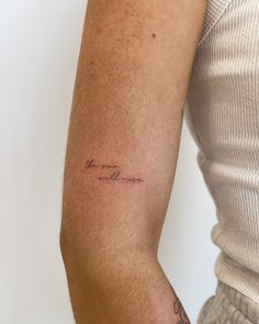 a woman's arm with a tattoo that reads, love is in the air