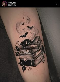 a tattoo with books and bats on it