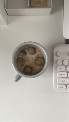 a cup of coffee sitting next to a calculator