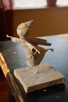 a paper mache figure on top of a wooden table