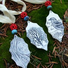 three handmade ornaments are laying on the ground