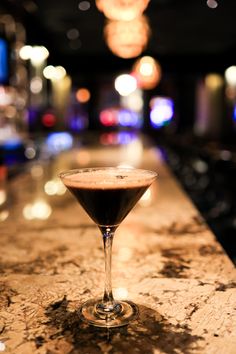 a martini glass sitting on top of a counter