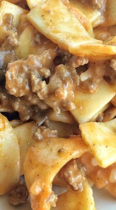 pasta with meat and sauce on a white plate