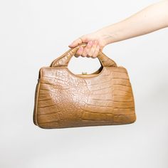 Vintage 80's handbag in caramel-brown crocodile-skin pattern - made in West Germany - the bag has handles for attaching a shoulder strap - material: no tag, In my opinion, the bag is made of leather MEASUREMENTS width: 14.5 inches (37 cm) height (without handle): 8 inches (20 cm) CONDITION - 8/10 - The bag in great vintage condition. Vintage Satchel Shoulder Bag With Crocodile Pattern, Retro Rectangular Bag With Crocodile Pattern, Handheld Textured Leather Brown Satchel, Brown Crocodile Pattern Top Handle Satchel, Vintage Textured Leather Top Handle Shoulder Bag, Brown Crocodile Pattern Evening Shoulder Bag, Evening Brown Crocodile Pattern Shoulder Bag, Skin Pattern, Top Handle Bags