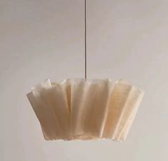 a white light hanging from a ceiling in a room