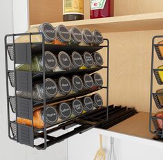 an organized spice rack in the kitchen with spices and seasonings on shelves next to utensils