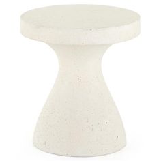 a white table with a round base on it's side, against a white background