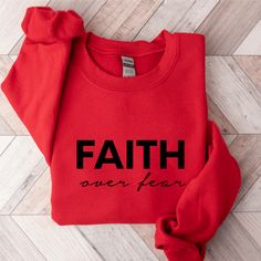 Keep warm and comfortable in this Faith Over Fear Sweatshirt. This cool Christian sweatshirt is soft, stylish, and sure to keep you warm in the colder months. It's versatile to wear for a day outdoors, heading to the gym, or a lazy day watching movies on the couch. Wearing Christian hoodies and sweatshirts can be a subtle way to express your faith and create conversations with anyone and be a gentle reminder to encourage you in any season. They can also spread encouraging words of faith everywhe Comfortable Sports Tops For Winter, Winter Fleece Sweatshirt With Letter Print, Winter Letter Print Fleece Sweatshirt, Comfortable Winter Crew Sweatshirt, Comfy Hoodie Sweatshirt With Letter Print, Comfy Letter Print Hoodie Sweatshirt, Winter Graphic Print Sweatshirt, Winter Graphic Print Comfortable Sweatshirt, Comfortable Graphic Print Winter Sweatshirt