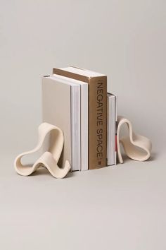 two bookends made out of books and one is shaped like an elephant's tail