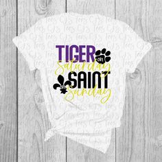 Soft t-shirt with CJ's Tees original LSU/Saints design. Shirts are unisex and fit true to size. Lsu Shirts Vinyl Women, Relaxed Fit T-shirt With Screen Print For Fan Gear, Relaxed Fit T-shirt With Screen Print For Fans, White T-shirt With Screen Print For Sports Fans, White T-shirt With Screen Print For Fans, White Pre-shrunk College T-shirt, College T-shirt With Sublimation Print And Relaxed Fit, Streetwear T-shirt With School Spirit Screen Print, Relaxed Fit Text Print T-shirt For Fan Gear