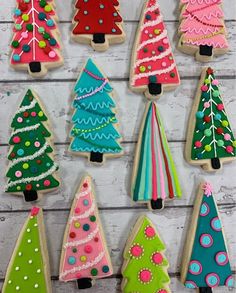 decorated christmas trees are displayed on cookies