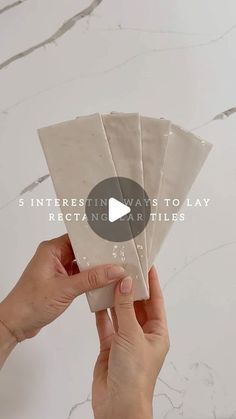 someone is holding up some paper with the words 5 interesting ways to lay rectangle art tiles