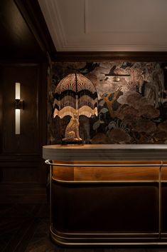 a bar with an umbrella on it in front of a wallpapered background and wood paneling