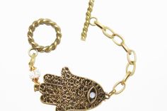 "Beautiful large Hamsa charm bracelet in antique bronze. Hamsa is about 2\" in size. The Hamsa is considered a gift of love. For those of you who are not familiar with the \"Bad Eye\" emblem, well, it's a symbol that's been around for thousands of years and is believed to protect and shield against the evil eye, generate positive energy, provide good fortune, health, prosperity and happiness. And since the Hamsa is considered a gift of love which makes it the perfect gift. CUSTOM ORDERS WELCOME Gold Bohemian Charm Bracelet Nickel Free, Bohemian Gold Charm Bracelet In Brass, Bohemian Gold Brass Charm Bracelet, Spiritual Bronze Nickel-free Bracelets, Nickel-free Bronze Spiritual Bracelets, Handmade Adjustable Brass Chain Bracelet, Gold Bohemian Evil Eye Bracelet, Handmade Gold Bohemian Charm Bracelet, Bohemian Gold Charm Bracelet Handmade