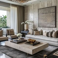 a living room filled with furniture and a chandelier hanging over the top of it