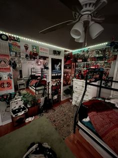 a room filled with lots of clutter and furniture next to a ceiling fan that has lights on it