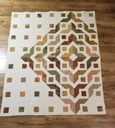 a quilted table topper on a wooden floor