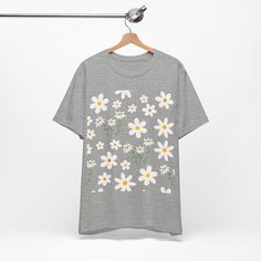 Featuring a breathable cotton fabric that ensures comfort and durability. The intricate daisy meadow design adds a touch of nature-inspired charm. This classic unisex jersey short sleeve tee fits like a well-loved favorite. These soft cotton t-shirts have-ribbed knit collars to bolster shaping. The shoulders are tapered for a better fit over time. Dual side seams hold the garment's shape for longer. .: Made with 100% Airlume combed and ring-spun cotton, a lightweight fabric (4.2 oz/yd² (142 g/m² Bottle Garden, 4th Of July Outfits, Red Strawberry, Blue Daisy, Heather Green, Coral Peach, Flower Shirt, Prism Color, Leisure Wear