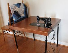 a sewing machine sitting on top of a wooden table