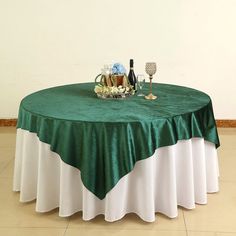 the table is covered with green and white linens