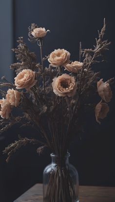 a vase filled with flowers on top of a wooden table