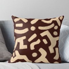 a brown and white pillow sitting on top of a couch