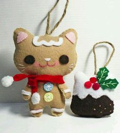 two christmas ornaments made to look like cats