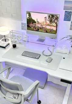 a white desk with a computer monitor and keyboard