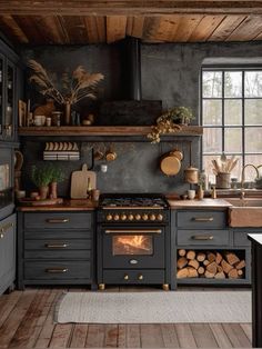 a kitchen with an oven, stove and counter tops in black painted wood planks