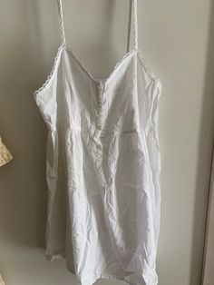 Super sweet sheer cotton babydoll nightgown or top. Victoria's Secret from the late 1980's. Lace trim. Very simple and sweet! Tagged petite small. Please use measurements.  Straps do not adjust.  Bust flat is 16 inches measured at the back. Length is 33 inches.  Pinhole mark on front right  bodice near buttons   pinhole near bottom of right strap on bodice  dime size very faint stain near right strap on bodice  Buttons up front of bodice  No returns. Final sale. Sold as is. 🌺 Summer Lace Bedtime Tops, Summer Nightgown With Delicate Lace For Bedtime, Summer Delicate Lace Nightgown For Bedtime, Summer Beach Nightgown With Lace Trim, Summer Delicate Lace Nightgown, White Ruffled Sleepwear For Summer, White Ruffled Nightgown For The Beach, White Spaghetti Strap Nightgown With Lace Trim, White Nightgown With Lace Trim And Spaghetti Straps