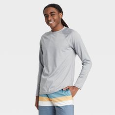 Stay comfortable on or in the water with the Regular Fit Long-Sleeve Rash Guard Swim Shirt from Goodfellow & Co™. This men’s rash guard features a regular fit with a solid hue for a no-nonsense look that’s perfect for hot days on the water. It’s made from soft fabric with added spandex for improved mobility and comfort, while UPF 50+ sun-blocking protection helps keep your skin safe from harmful sun rays. Whether you’re wading through the water or relaxing on the boat, this solid-color rash guar Mens Measurements, Swim Shirt, Sun Shirt, Swim Shirts, Sun Rays, Slim Fit Shorts, Hem Style, Man Swimming, Flat Chest