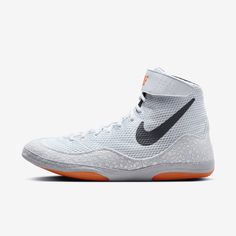 the nike zoom basketball shoe in white and black with an orange soles on top