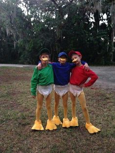 three people in duck costumes posing for the camera