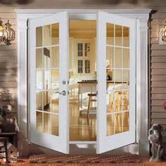 an open french door in the middle of a living room