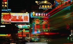 a city street filled with lots of neon signs