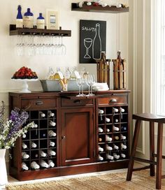 a bar with wine glasses and bottles on it