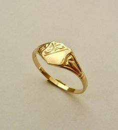 100% AUSTRALIAN MADE BRAND NEW GENUINE SOLID 9ct YELLOW GOLD UNISEX SHIELD SIGNET RING GENUINE SOLID GOLD NOT FILLED - NOT PLATED - NOT HOLLOW HALLMARKED (Stamped) 9ct 375 Ring weight : 1.2 grams approx. Ring width : 7 mm approx. widest point tapering to 2 mm approx. Ring size : L ( AU-UK ) and 6 US FINEST QUALITY HIGHLY POLISHED crafted with Precision    Our QUALITY is GUARANTEED. Buy with confidence. If you are not satisfied for any reason you can return it for a full refund. No postage charge Antique Gold Signet Ring With Diamond Cut, Gold Art Deco Signet Ring For Gift, Gold Art Deco Signet Ring Gift, Art Deco Gold Engraved Ring For Gift, Gold Art Deco Engraved Ring As Gift, Gold Engraved Art Deco Ring For Gift, Gold Art Deco Rings With Hallmarks, Signet Rings Women, Shield Ring