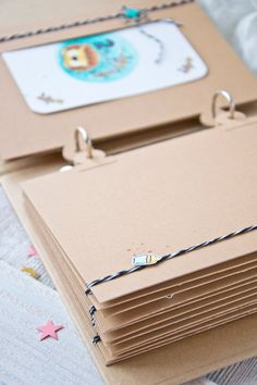 a stack of brown envelopes sitting on top of a bed next to each other