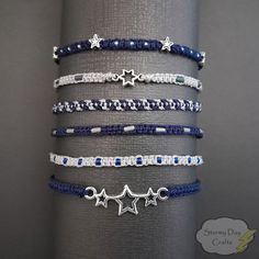 Welcome to Stormy Day Crafts, where style meets celestial charm! Introducing our Midnight Stars Stackable Friendship Bracelet Sets - crafted to add a touch of enchantment to your everyday moments. ⭐ Set of 6, Set of 3, and Individual Bracelets: Choose from our versatile options: Full set of all 6 bracelets, a set of 3 bracelets, or individual bracelets to suit your preferences. Mix and match for a ook that's uniquely yours. In Set A 1: Dark Blue with Silver Beads 2: Light Grey with Blue Beads 3: Dark Blue Beaded Bracelet, Blue Friendship Bracelet Patterns, Trio Friendship Bracelets, Friendship Bead Bracelets, Star Friendship Bracelet, Trio Bracelets, Dark Blue Bracelet, Blue Friendship Bracelet, Midnight Mayhem