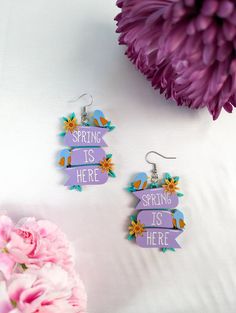 "Introducing our \"Spring is Here\" acrylic earrings, featuring delicate flowers and charming birds in a cheerful and colorful design that's perfect for the season. These earrings feature flowers and birds, symbolizing the beauty and new beginnings of the spring season. Crafted from quality acrylic, these earrings are comfortable and durable. All details are intricately laser-cut into acrylic, creating a unique design that is sure to turn heads. So why wait? Add a touch of spring to your jewelry collection with our \"Spring is Here\" earrings and embrace the beauty of the season in style!" Whimsical Spring Flower Earrings For Gift, Whimsical Spring Flower Earrings With Ear Wire, Whimsical Spring Earrings For Pierced Ears, Whimsical Spring Earrings, Whimsical Spring Earrings For Gift, Whimsical Flower Earrings For Spring, Whimsical Earrings For Spring Gift, Whimsical Spring Flower Earrings, Cute Hypoallergenic Earrings For Spring