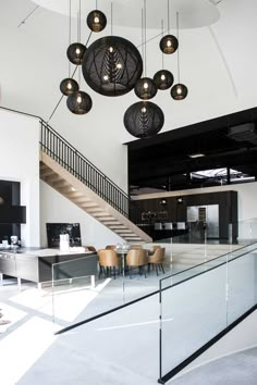 an open floor plan with modern lighting fixtures