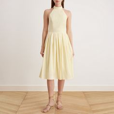 Look beautiful in this Knee-length Sleeveless Dress with a Short Turtleneck in Cotton. It is tailored to flatter and embrace your curves, creating an elegant and glamorous look. 
 Knee-length Sleeveless Dress with a Short Turtleneck Glamorous Look, Look Beautiful, Light Yellow, Knee Length, Sleeveless Dress, Turtle Neck, Yellow, Black