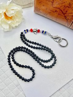 "Short Petite ID Lanyard for women 5\"2\" and under. Perfect for Flight Crew wearing Red, Black, Blue and Yellow uniform pieces. This adorable Airplane lanyard is elegant... and cute!  With the Pewter Airplane bead, surrounded by Black Pearls and glass beading in blue, red, clear and yellow, this Airplane Jewelry ID Lanyard is colorful and ready to fly!  The nape is full of 8mm Black glass pearls, giving a comfortable wear. I've crafted this Jewelry Lanyard a Short Petite 32\" length.  On strong beading wire, a removable hook system (if your hook ever breaks), and a strong hook and key ring, you'll be able to keep all your airline essentials close while staying pretty." Adjustable Black Lanyards For Personal Use, Black Lanyard With Key Leash As Gift, Black Lanyard With Key Leash For Personal Use, Adjustable Black Lanyards For Everyday Use, Adjustable Black Badge Holder With Key Leash, Adjustable Black Lanyards For School, Adjustable Black Lanyard For School, Jewelry Lanyard, Yellow Uniform