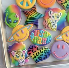 there are many different decorated cookies in the box together with peace, love, and animals