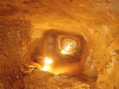 candles are lit in the middle of a tunnel