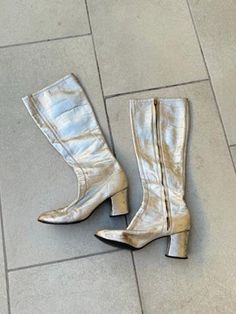 1960s Silver Metallic Leather Gogo Boots by Millie's. Women's size 5.5 B. Metal side zipper on inner side of boots. They are just below knee high length with shaft measuring 14" from top of boot to the top of the heel and 16.5" total length from top to bottom of boot. 3" wide measurement taken from bottom of sole. Soles look to be in excellent condition. Chunky 2.5" heel. Round square toe shape. There are obvious signs of previous wear and age: surface scuffs and wear and a few heel nicks. Perfe Vintage Party Boots, Retro Fall Heeled Boots, Retro Leather Party Boots, Vintage Knee-high Boots For Party, Vintage Leather Heeled Boots For Party, Vintage Leather Party Boots, Vintage Leather Boots For Party, Gogo Boots, San Rafael