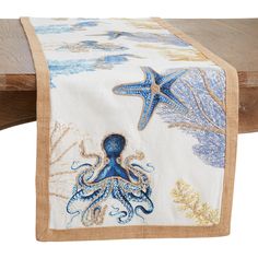 an octopus and starfish table runner on a wooden bench